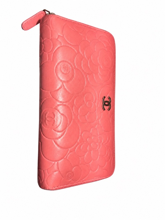 CHANEL Handbags - Chanel Pink Camellia Embossed Zip Around Wallet.